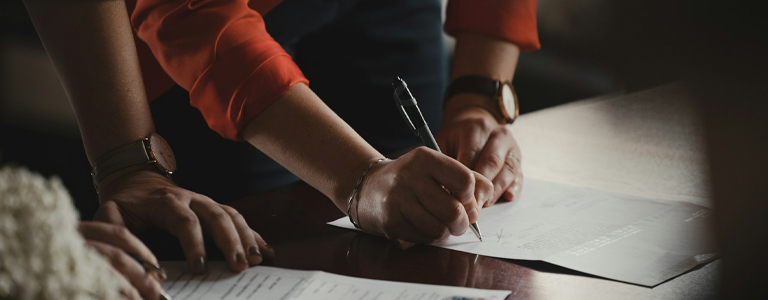 Corporate lawyer in Edmonton signing a document