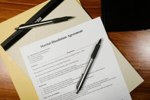 Marital dissolution agreement with pen on desk